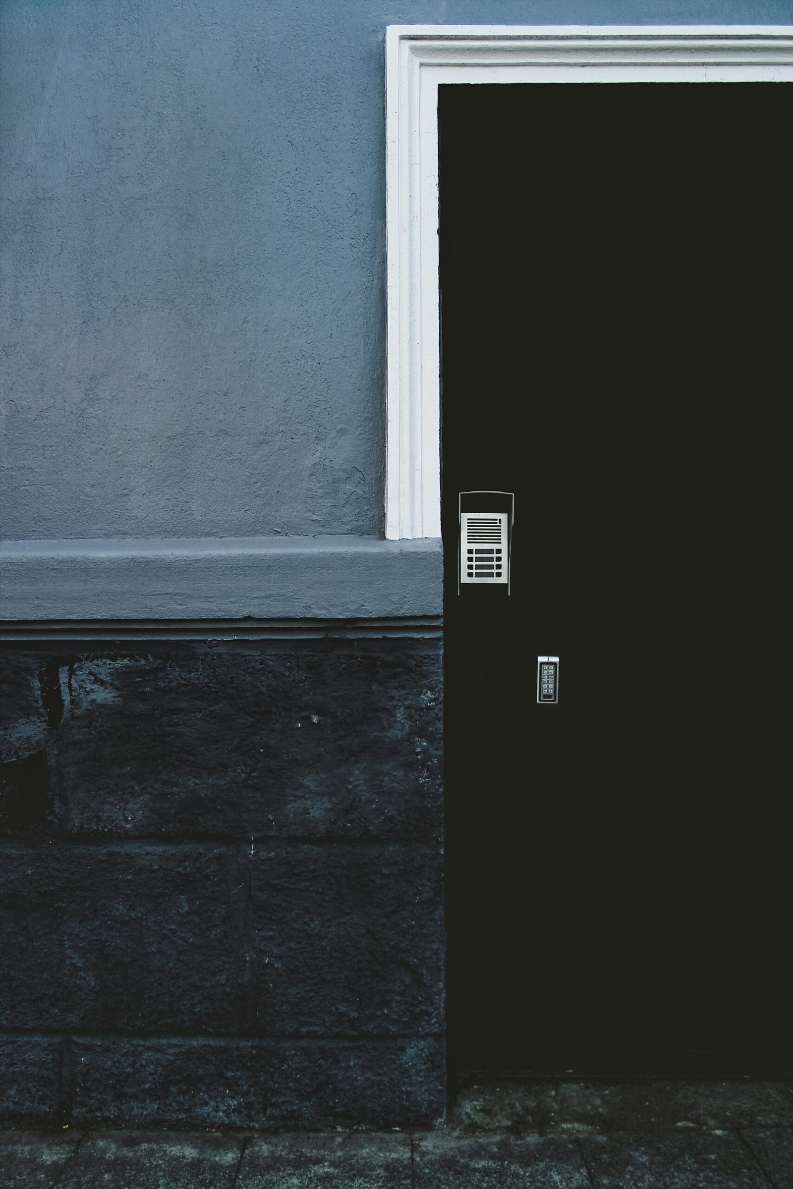 A contemporary dark door with a security keypad offers modern design and safety.